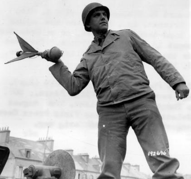 Can you identify the German anti-tank weapon held (incorrectly) by a U.S. soldier in this photo?